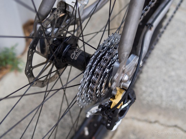 This Hope SS/Trials hub with bolt-through axle is much lighter than the fat-Rohloff and stiffens the rear end too.  Although singlespeed is possible, I've allowed my knees the luxury of some gears.  This selection cover the range I need pretty well, but does force me to free-wheel (loudly) on the fastest downhill stretches.