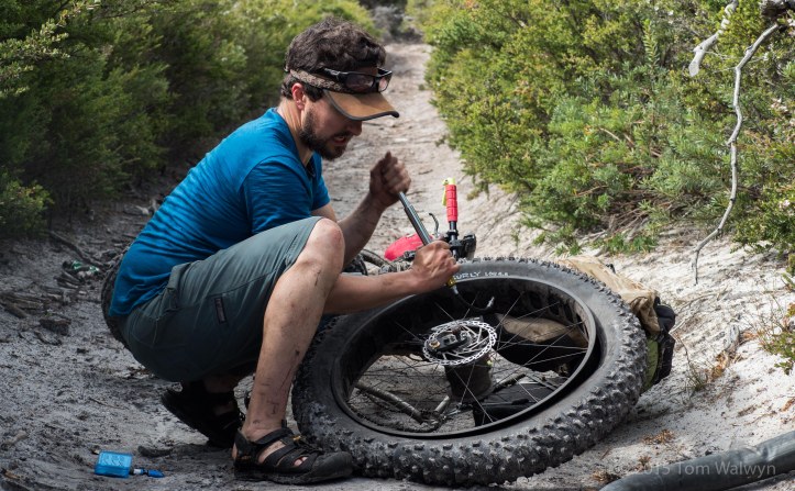 Scott working on the only puncture of the trip - the result of whoop-bombing down a steep rocky descent :-)